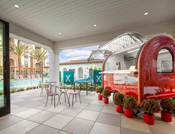 Xanadu: pool side cabana with kitchen, hang out spaces, and food trailer on outdoor patio